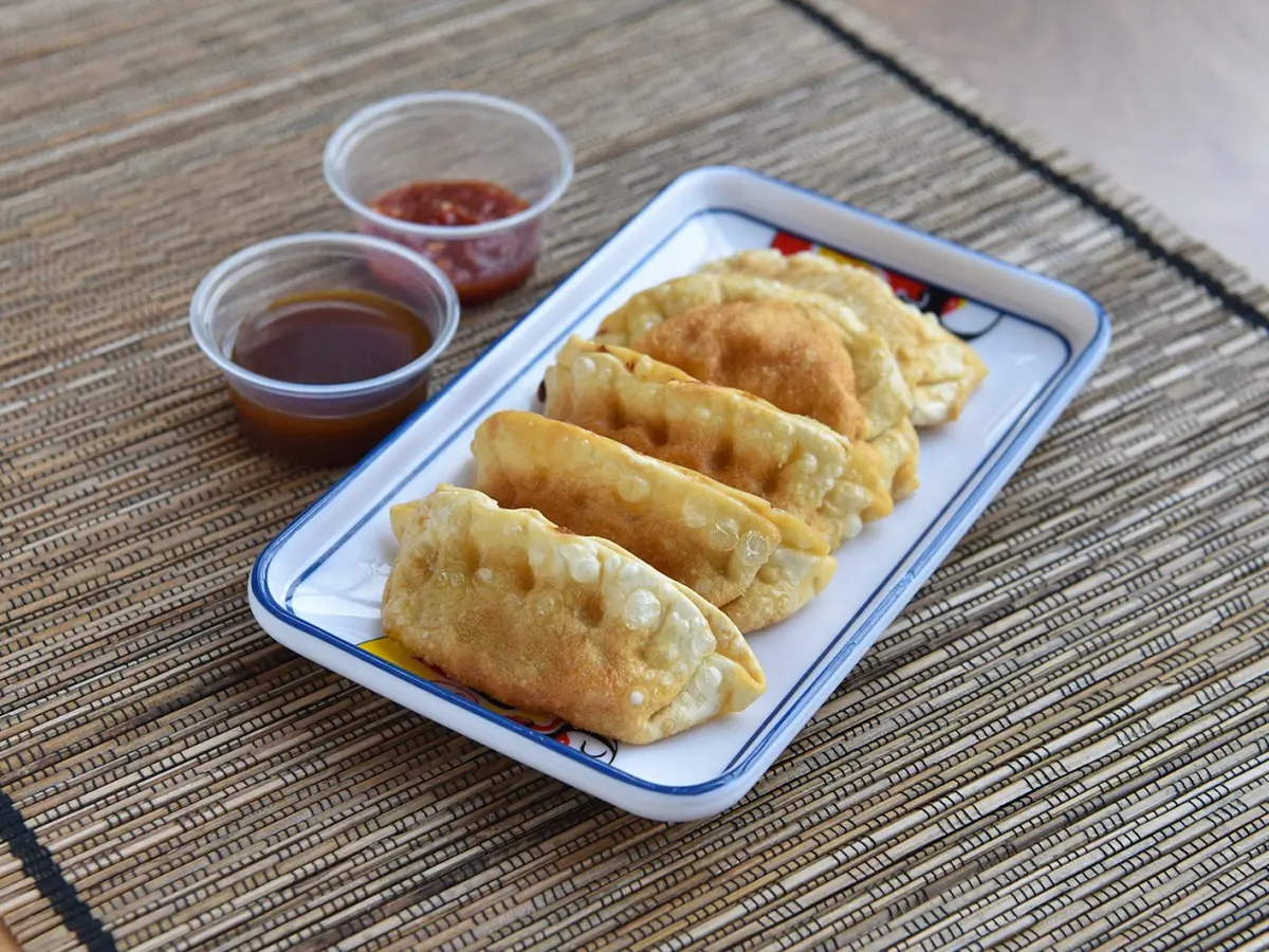 Pan - Fried Dumplings are golden - brown, crispy - skinned dumplings filled with savory ingredients