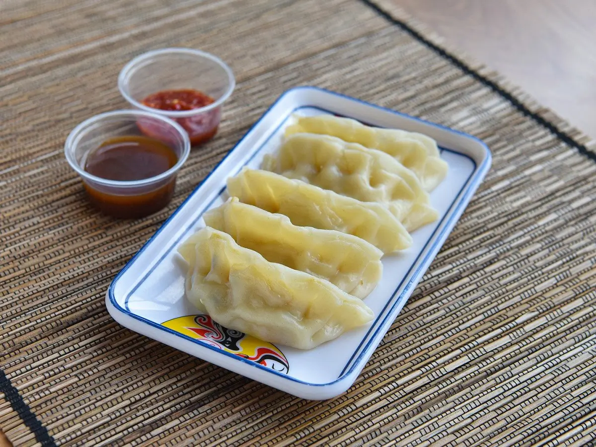 Steamed Dumplings are soft - skinned dumplings filled with savory ingredients